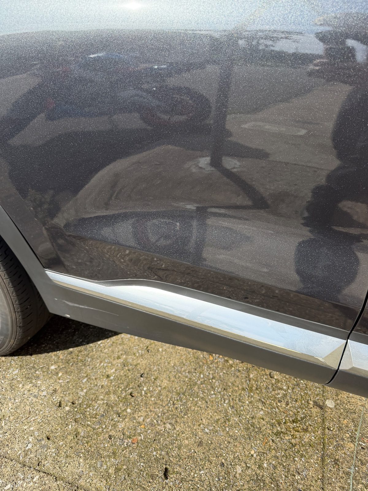 Clean lower rear door of a dark grey Hyundai Santa Fe after detailing