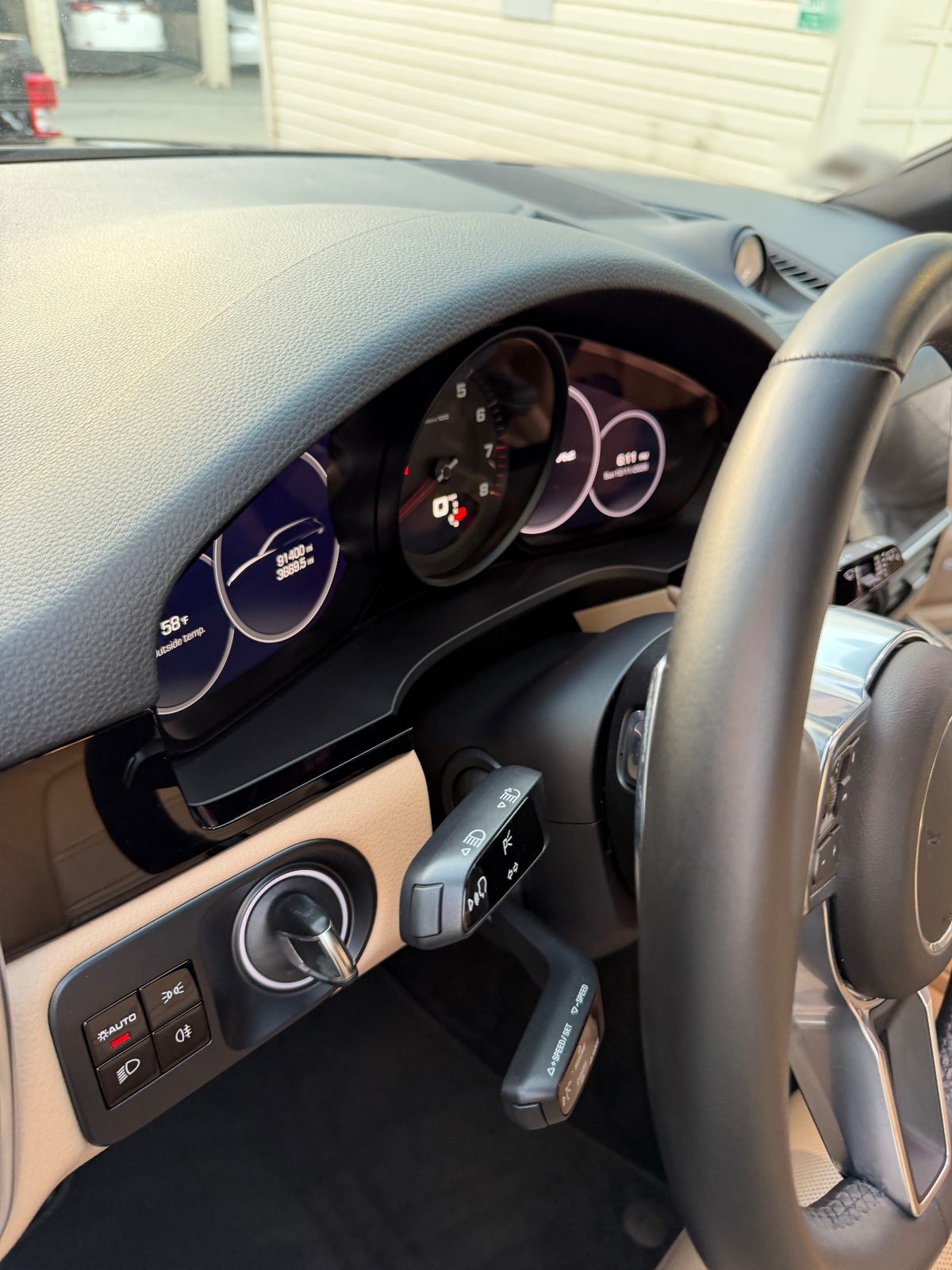 Instrument cluster and steering column of a Porsche Cayenne after detailing, showing 91,400 miles