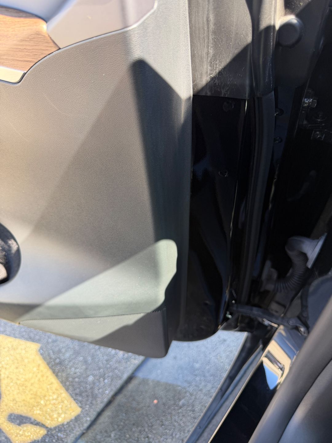 Clean lower door panel and door jamb of a Tesla Model Y after detailing
