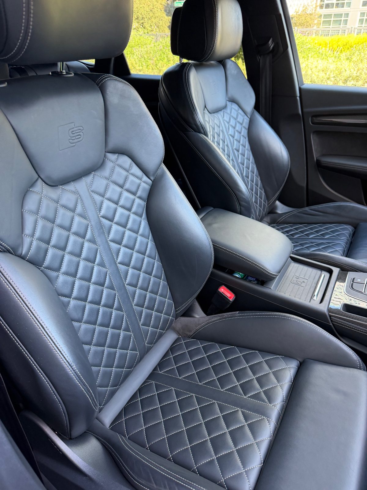 Clean quilted leather front seats of an Audi SQ5 after detailing