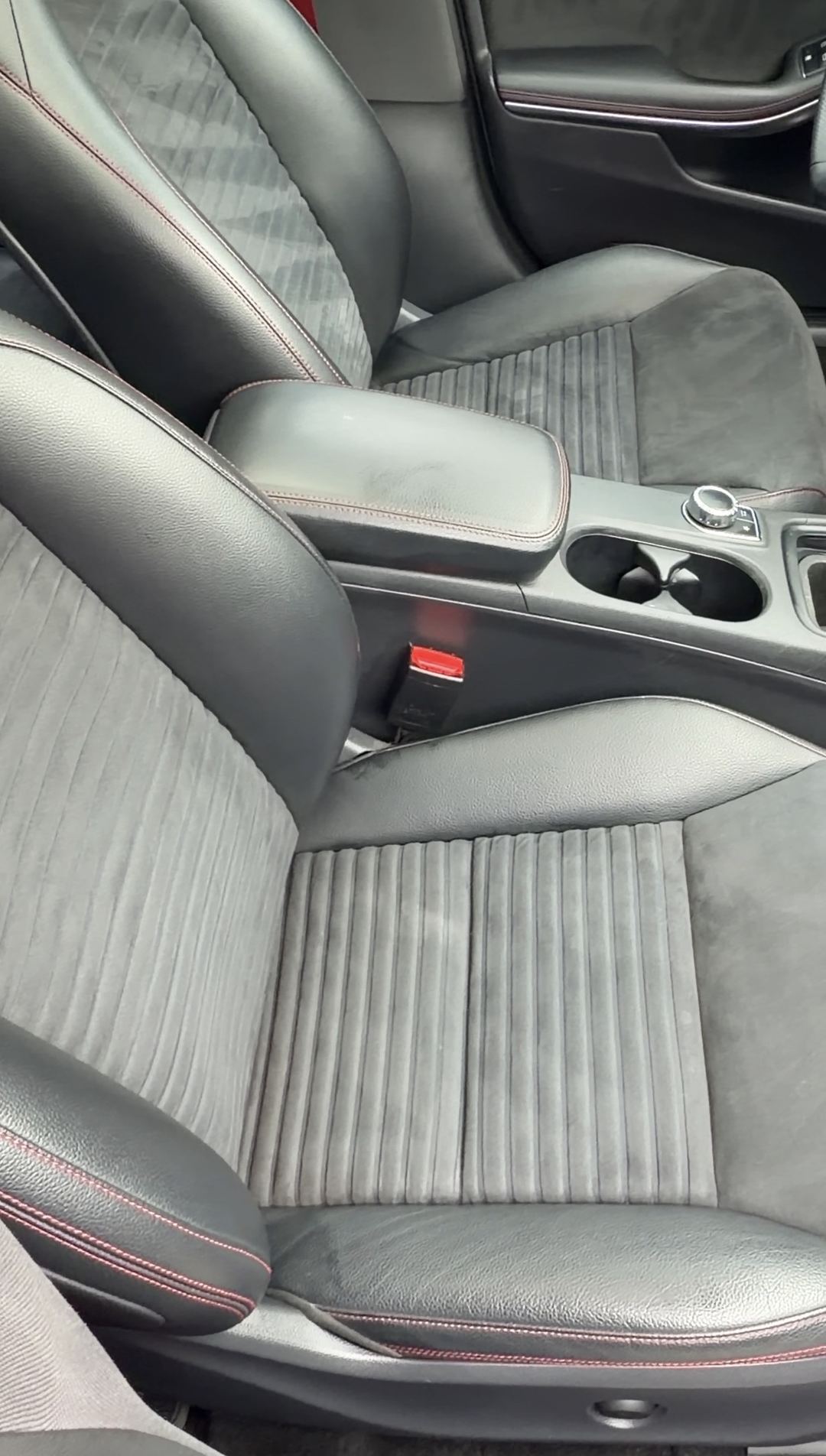 Cleaned front seats and centre console of a Mercedes-Benz CLA250 with grey microfibre and red stitching