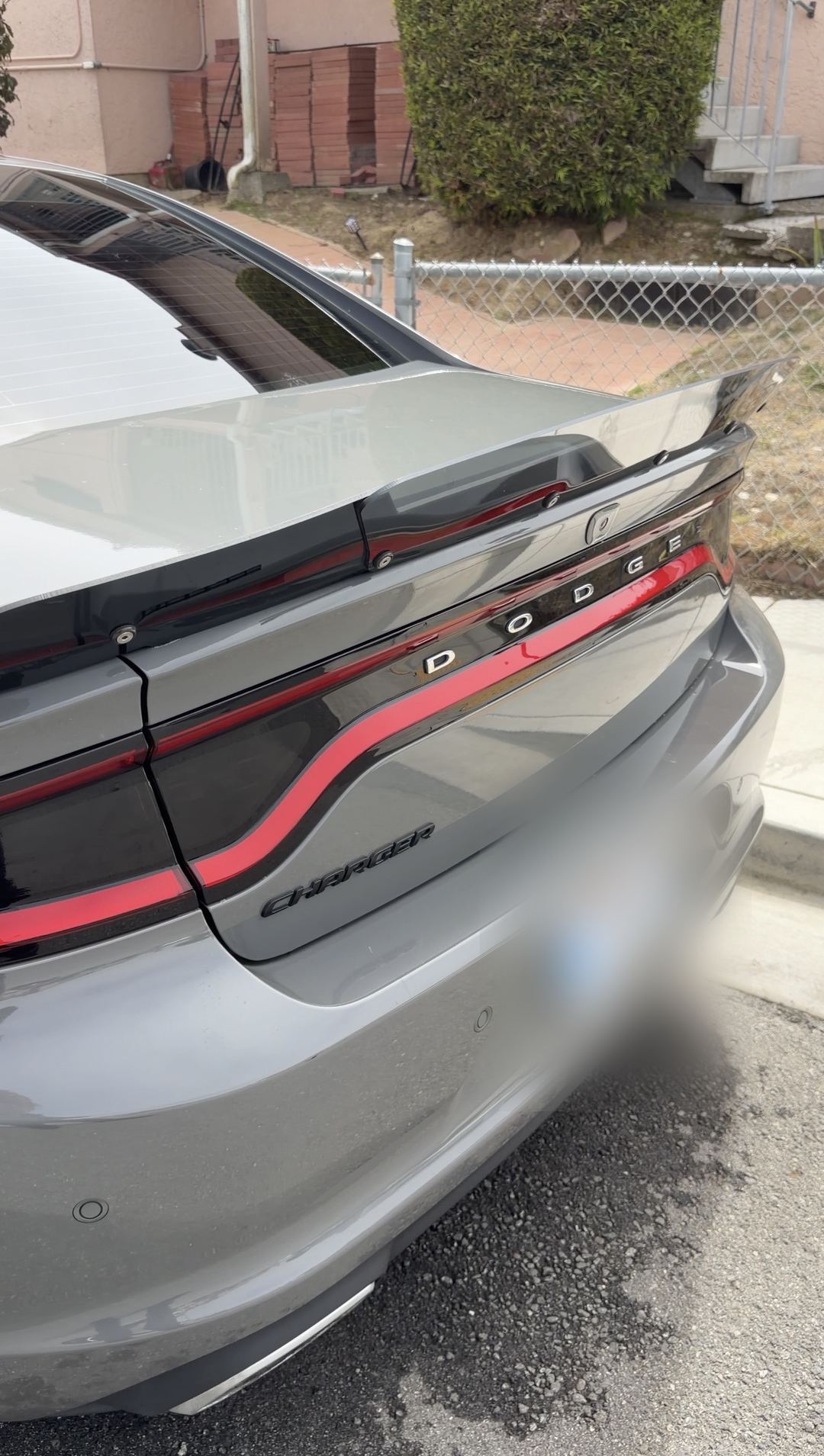 Rear of a clean grey Dodge Charger with DODGE and CHARGER lettering