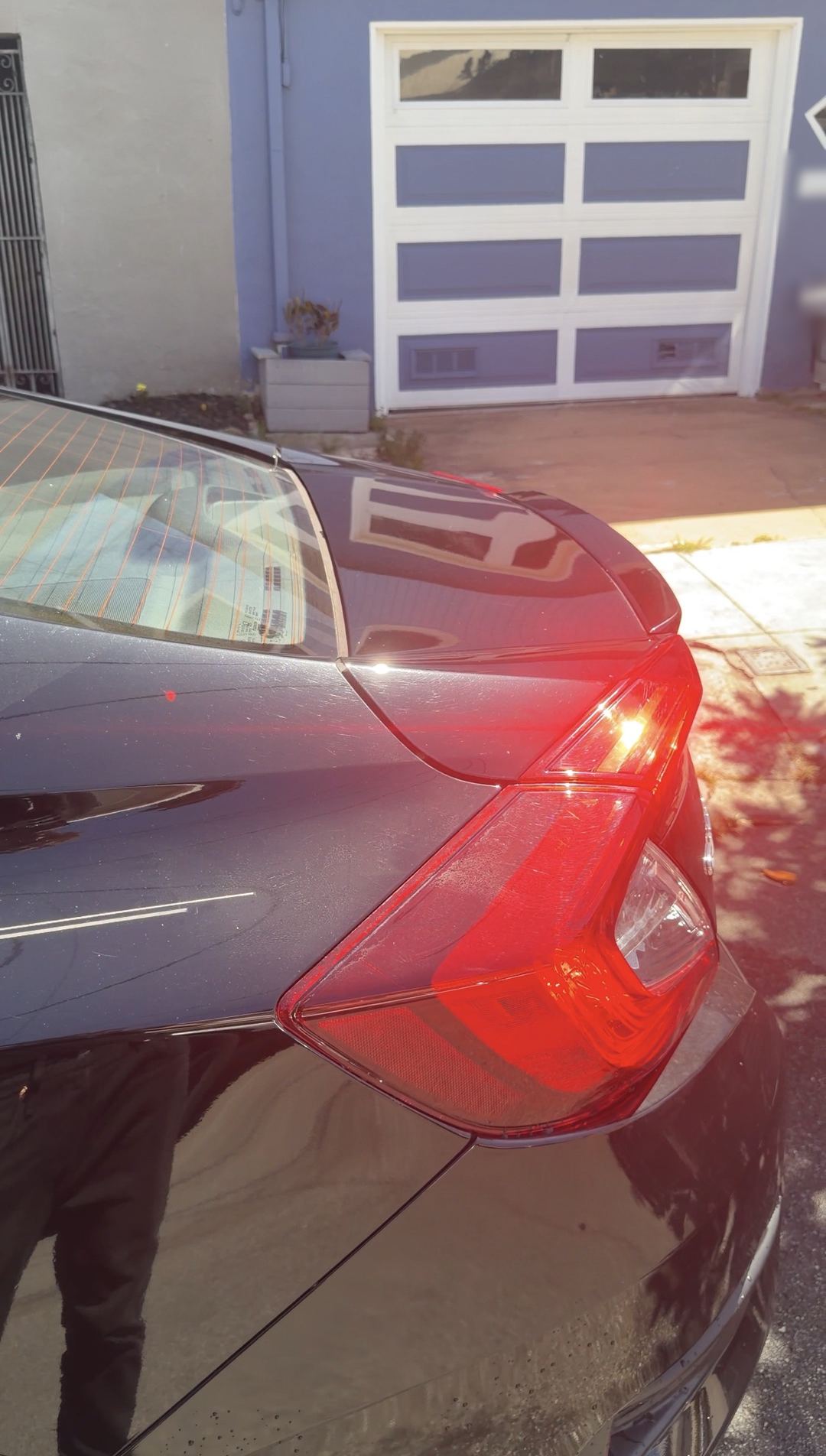 Clean taillight and rear quarter panel on a black Honda Civic