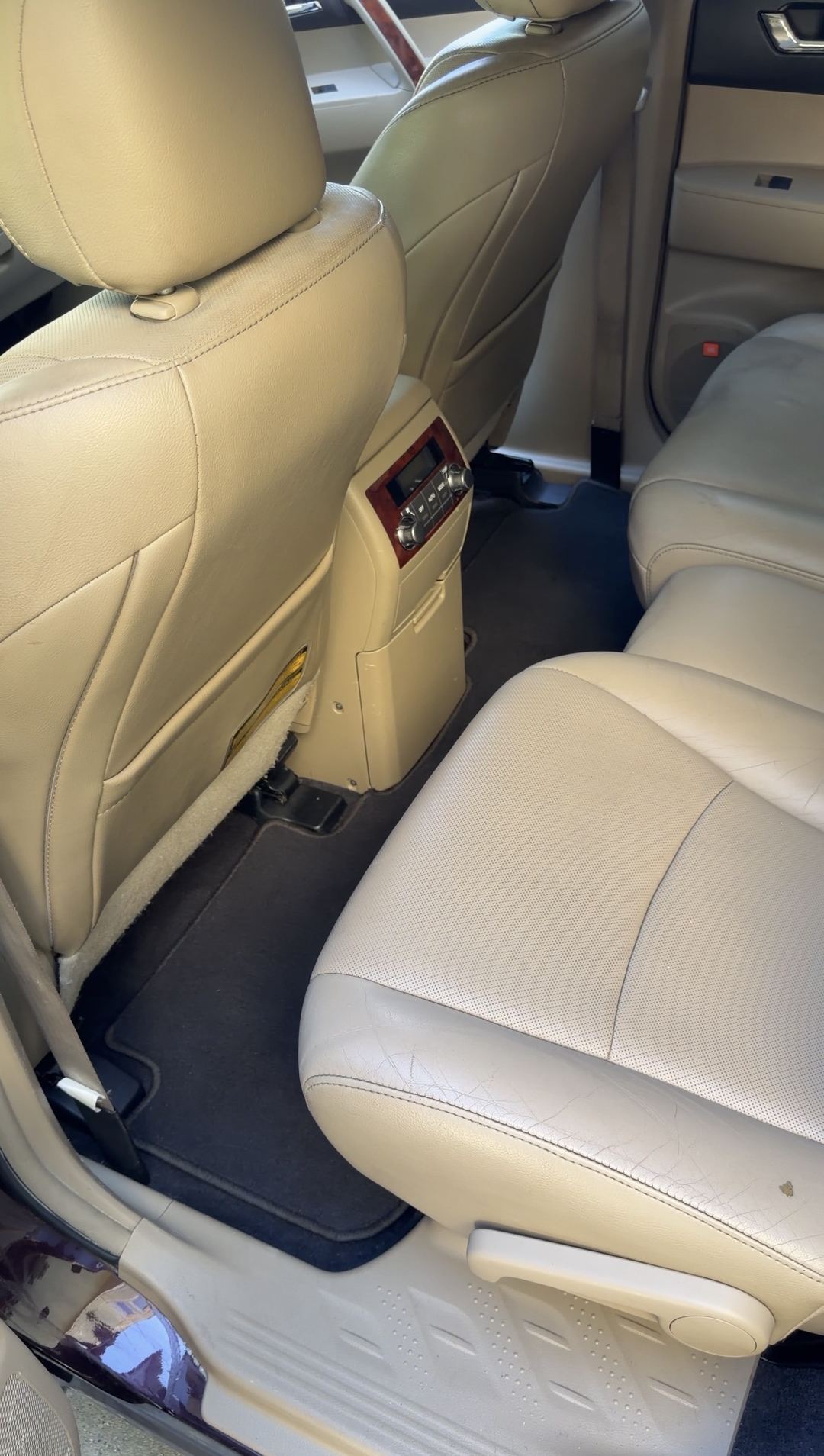 Clean second-row seat, floor mat and sill on the driver side of a Toyota Highlander