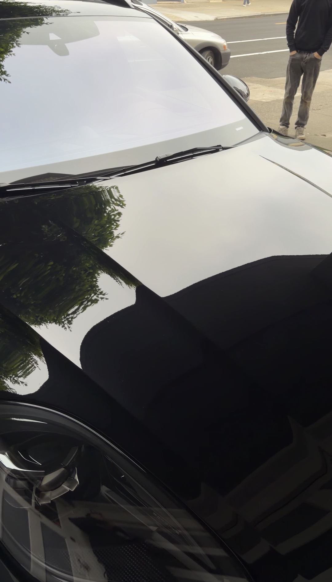 Mirror-clean hood of a black Porsche Macan GTS after a mobile exterior detail in San Francisco.