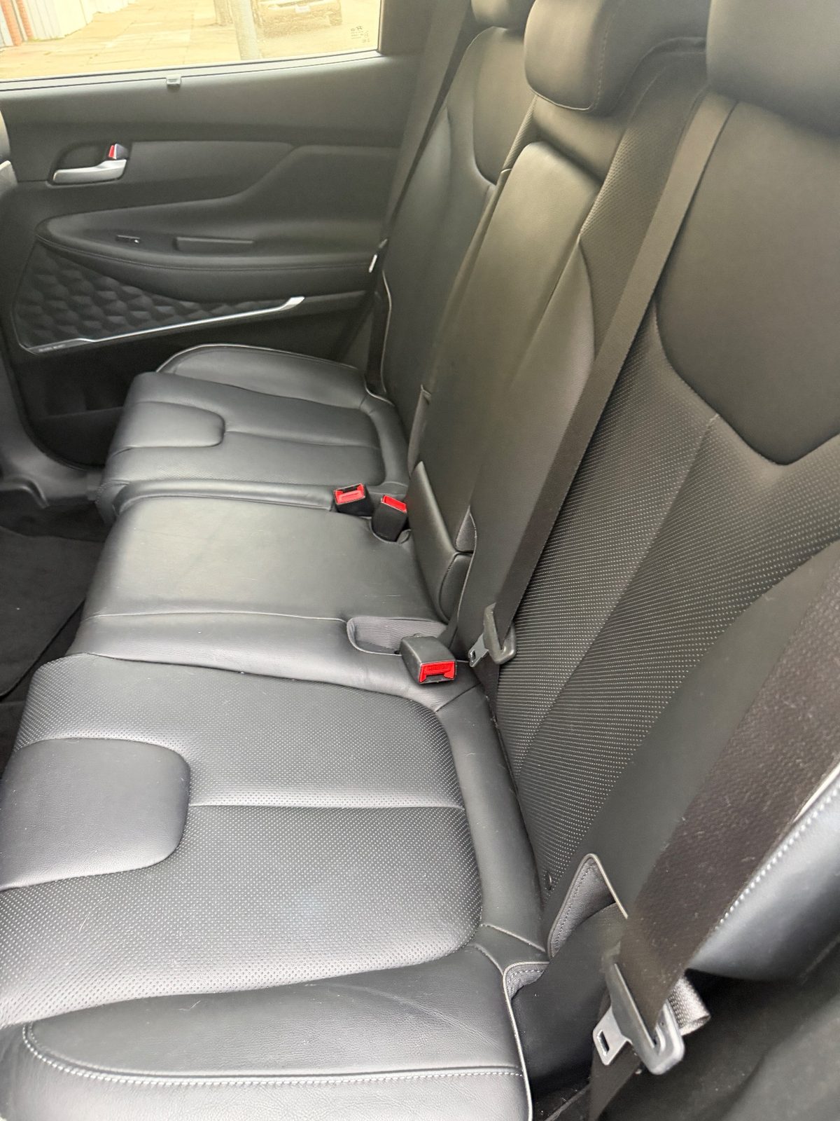 Rear leather bench seat of a Hyundai Santa Fe before detailing