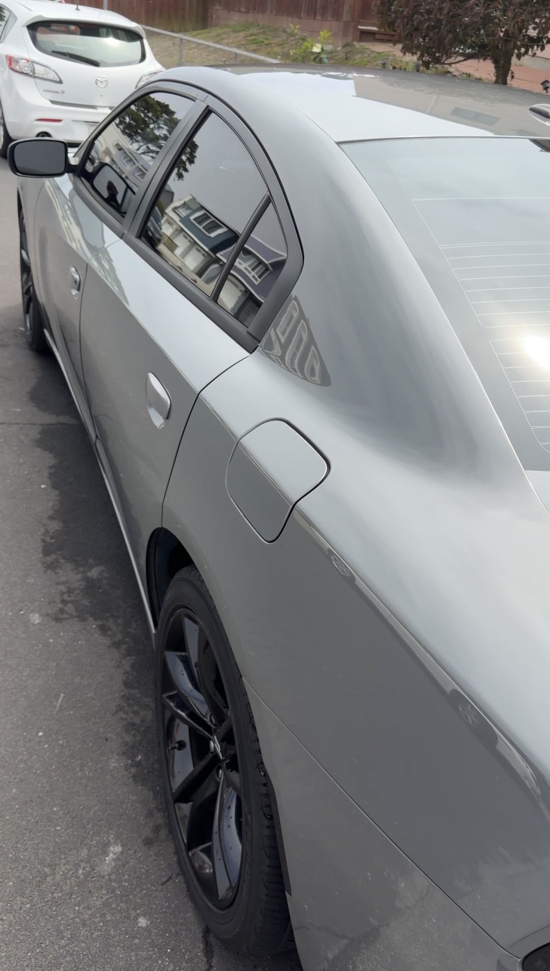Clean grey Dodge Charger rear window and side after an exterior detail