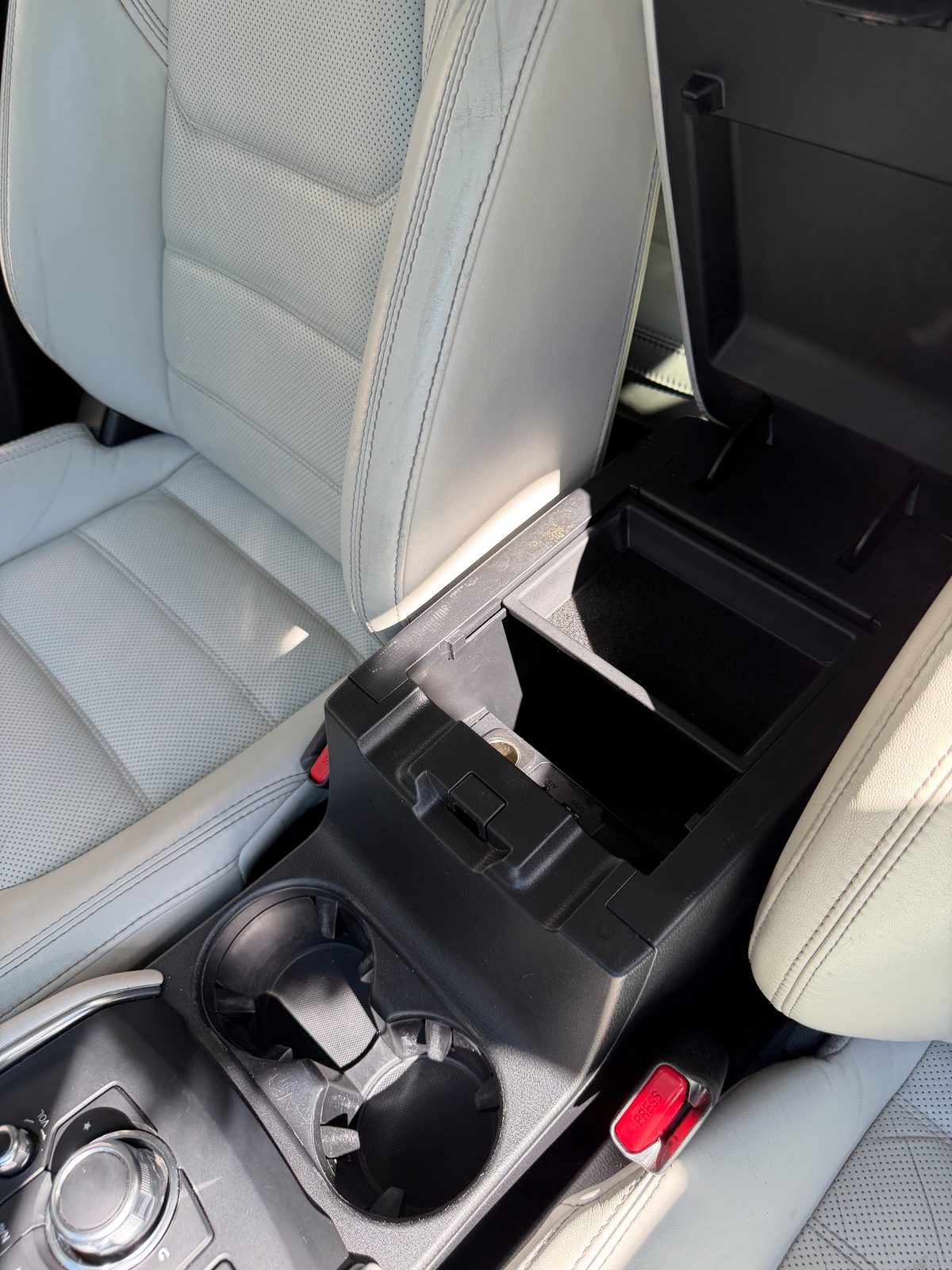Clean open centre armrest and cupholders of a Mazda CX-5 after detailing