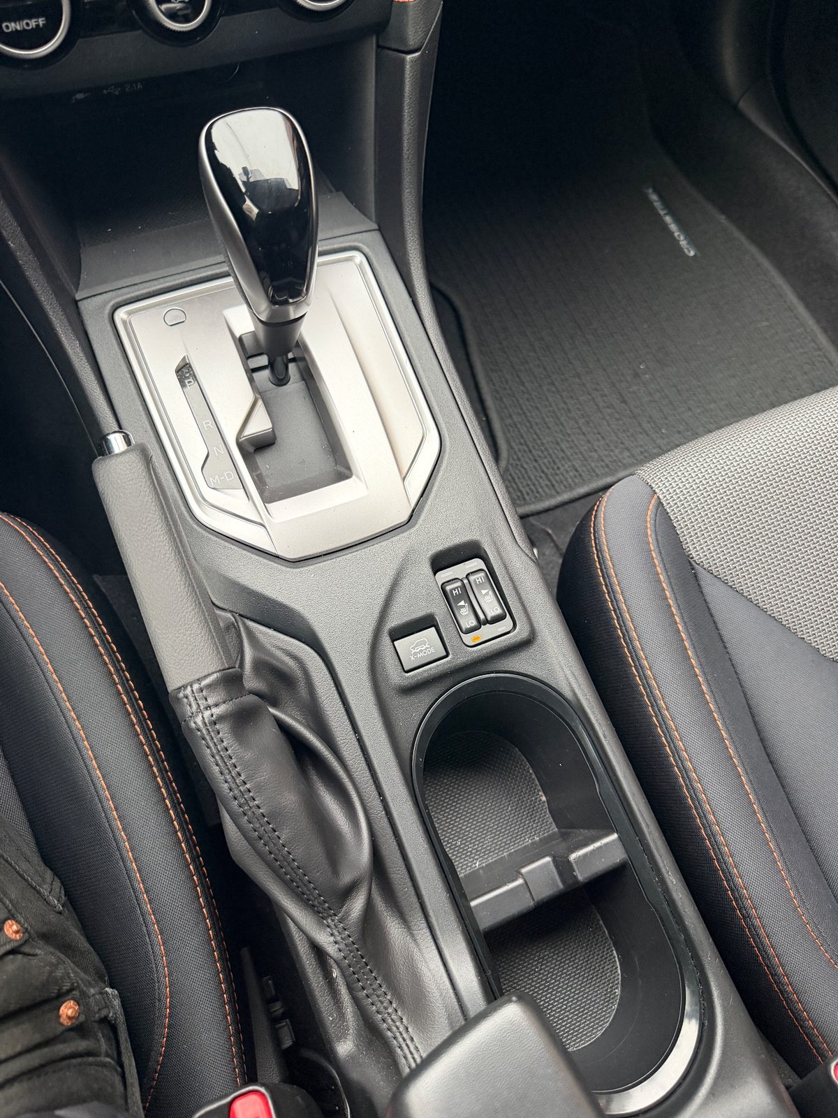 Centre console and shifter of a Subaru Crosstrek before interior cleaning