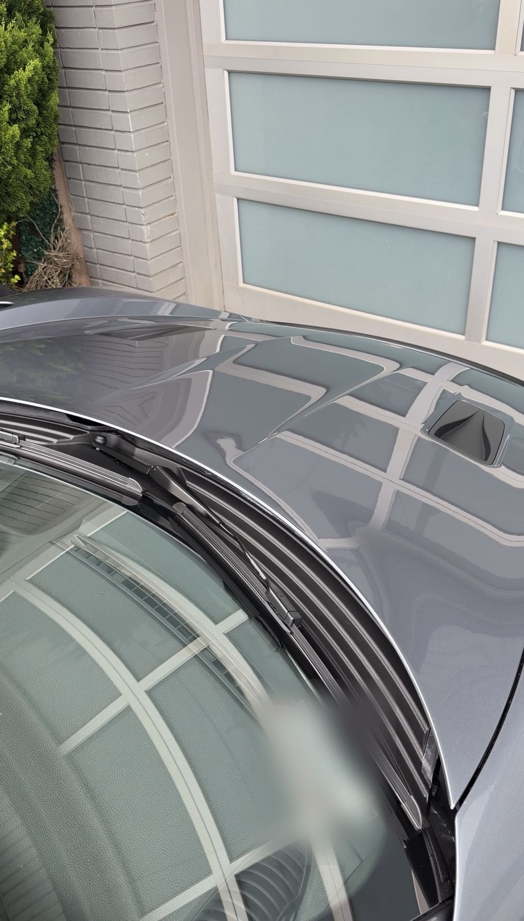Clean cowl, wiper and windscreen edge of a grey Porsche 718 Spyder RS after a mobile detail.