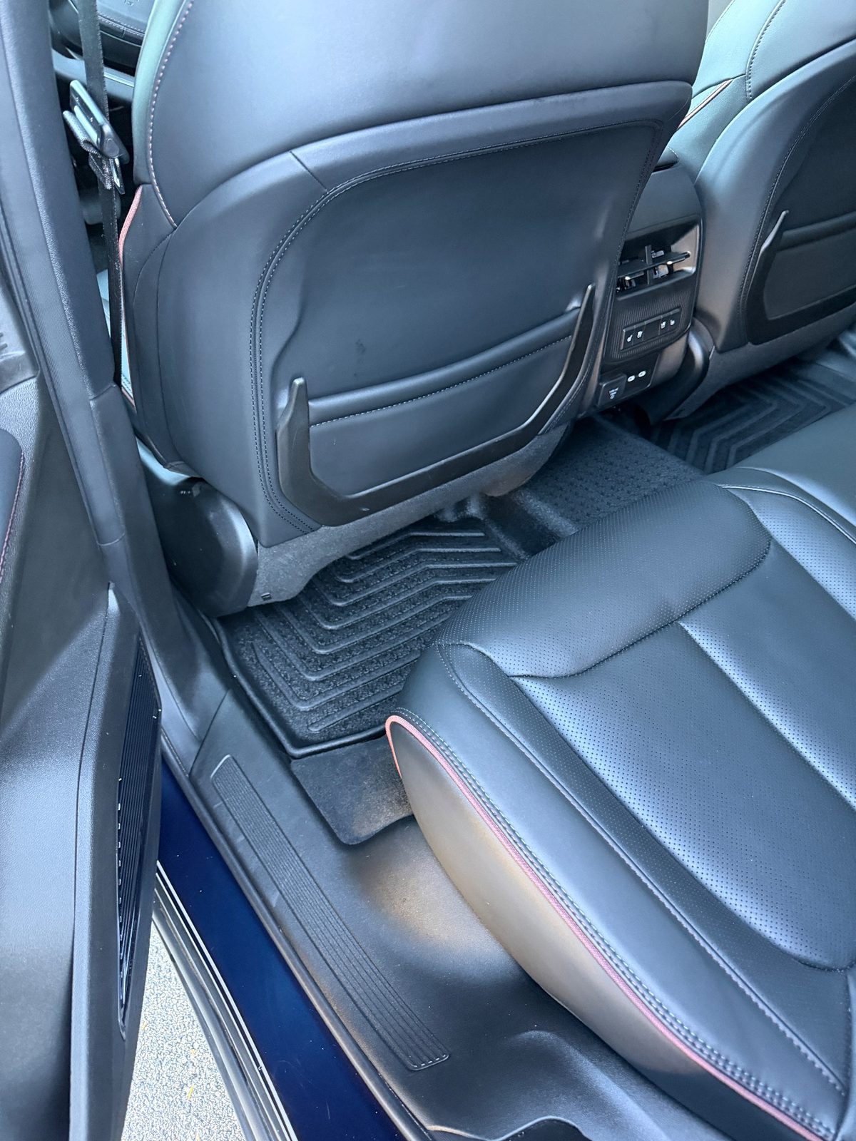 Clean rear footwell of a Jeep Wagoneer S after detailing
