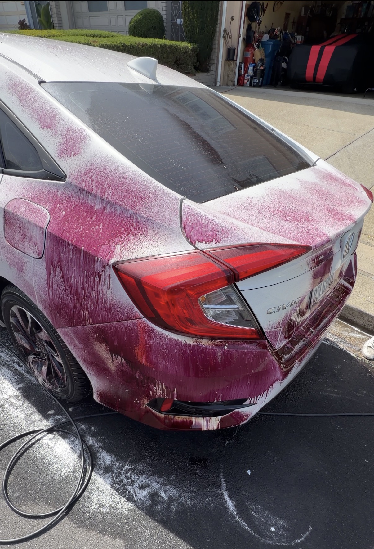 Iron decontamination chemical reacting on Honda Civic rear quarter panel during SF City Wash paint decon service