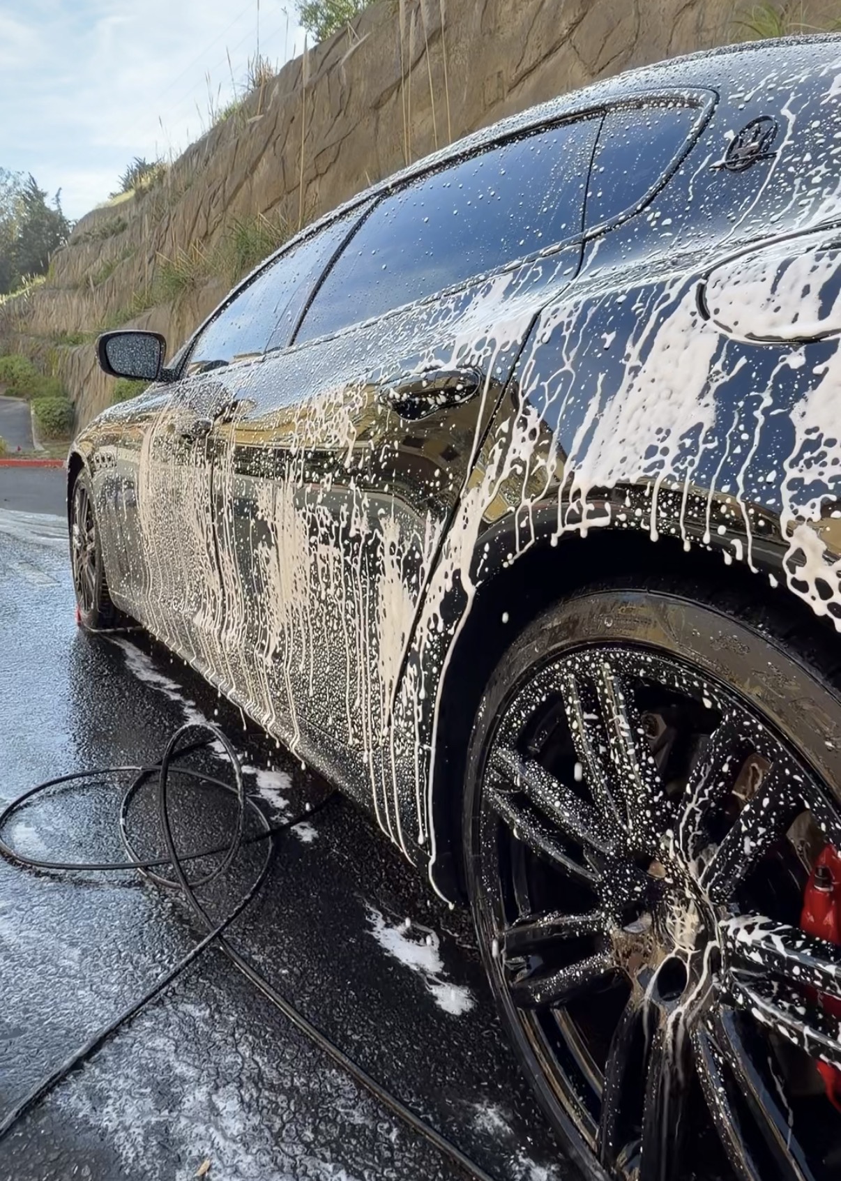 Foam decontamination application on vehicle exterior during SF City Wash mobile detail in San Francisco