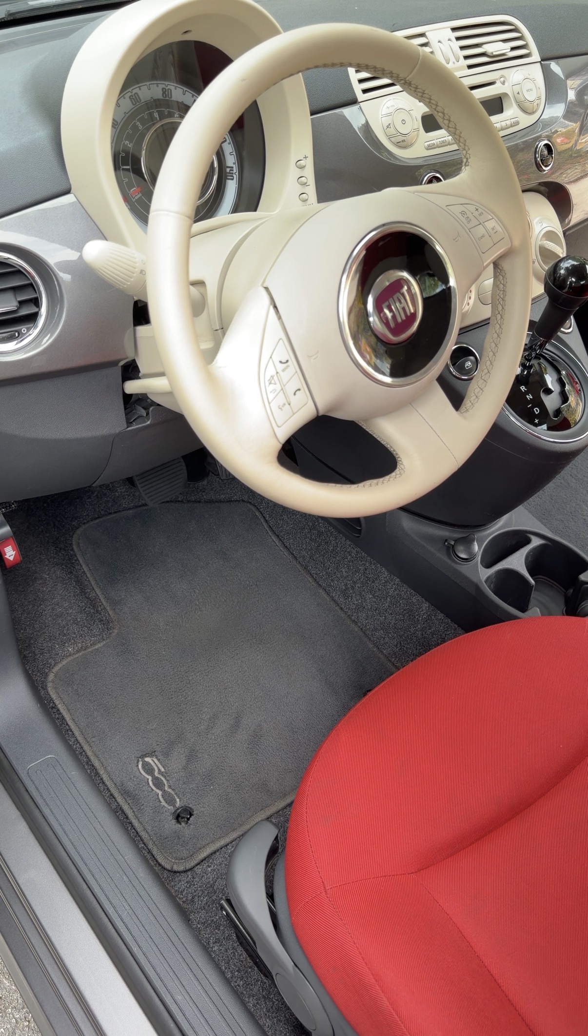 Fiat 500 driver footwell after detailing, clean carpet