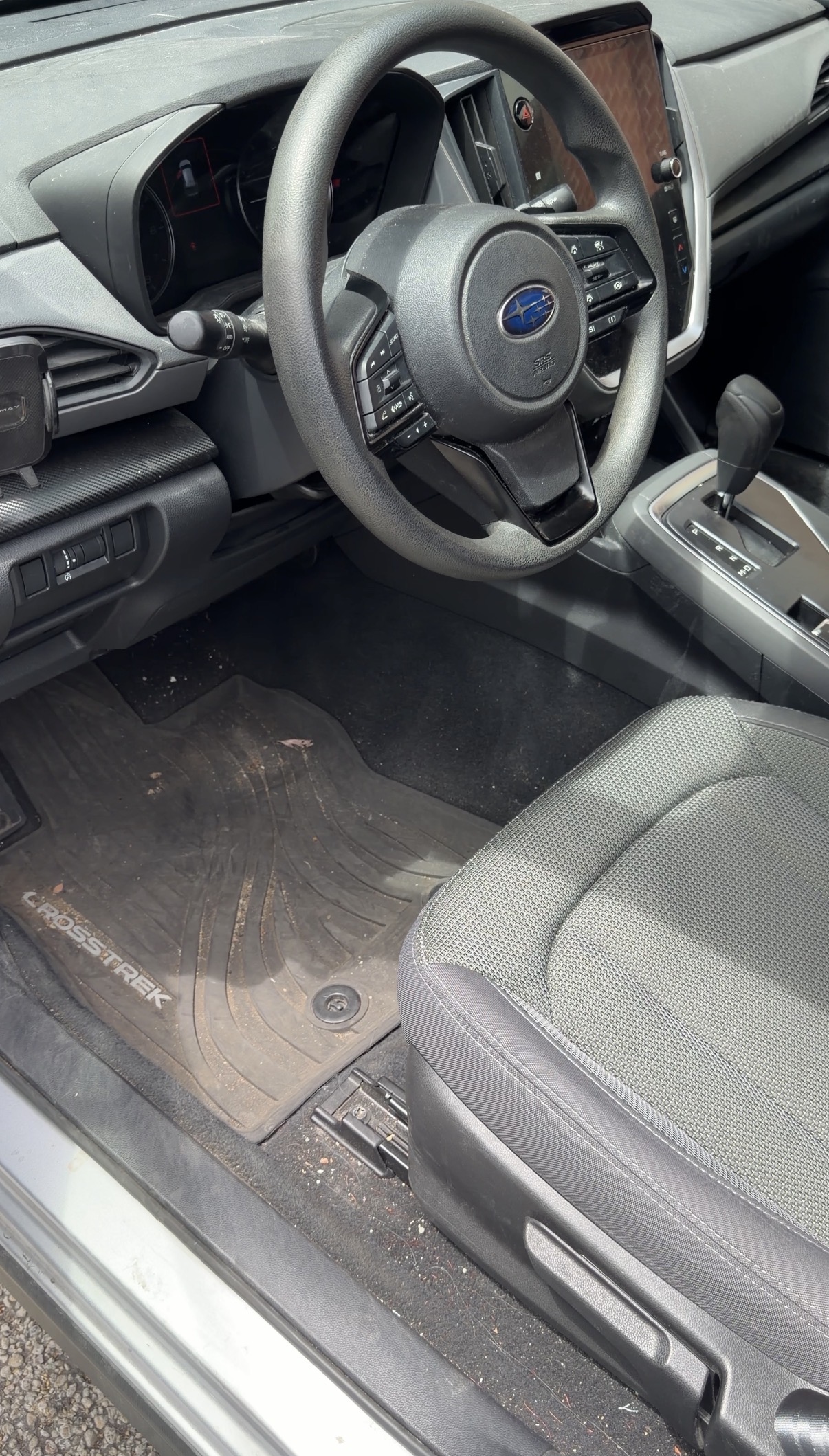 Subaru Crosstrek driver floor mat before detailing, dusty