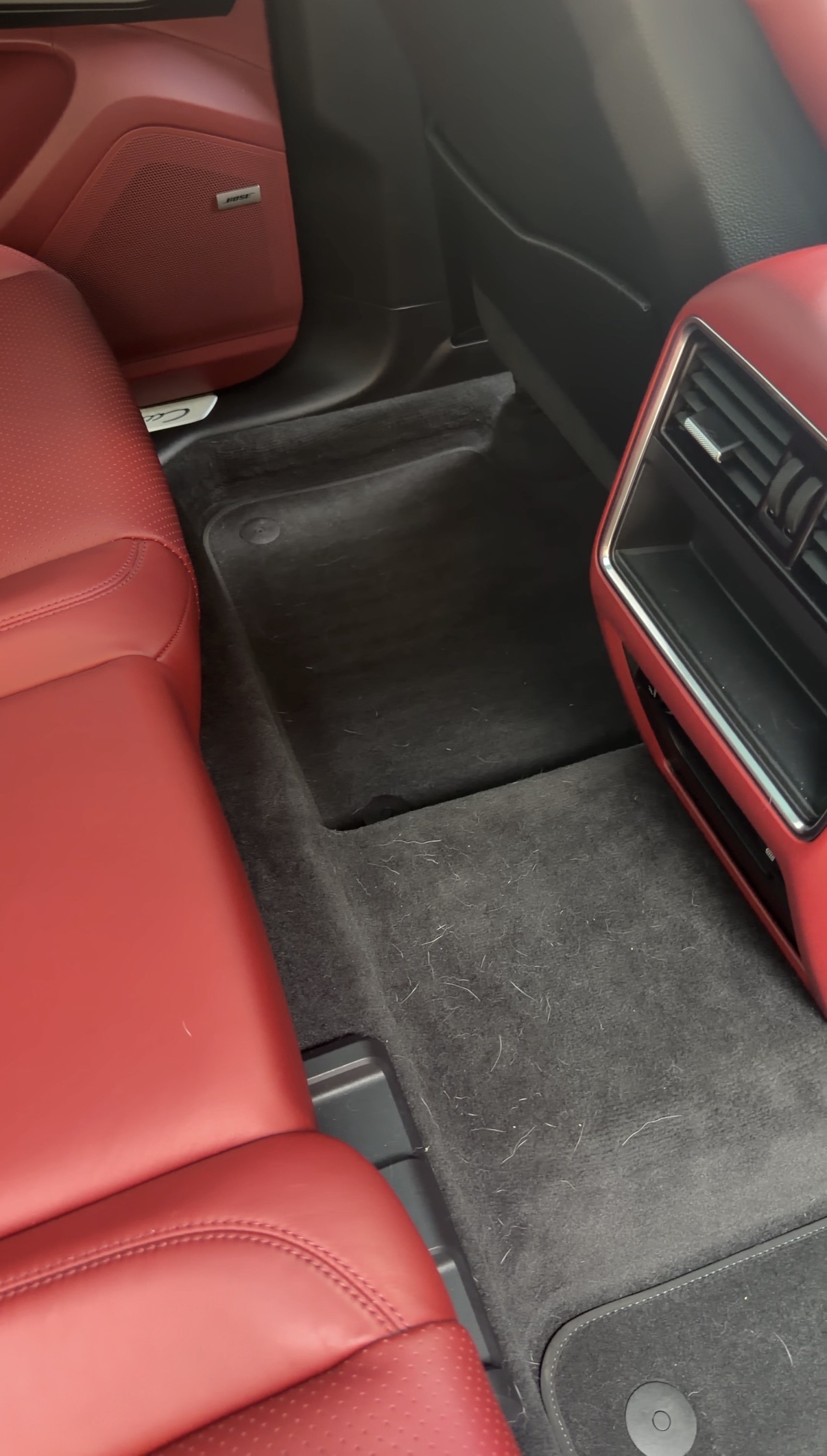 Porsche Cayenne rear seat floor before detailing, pet hair visible