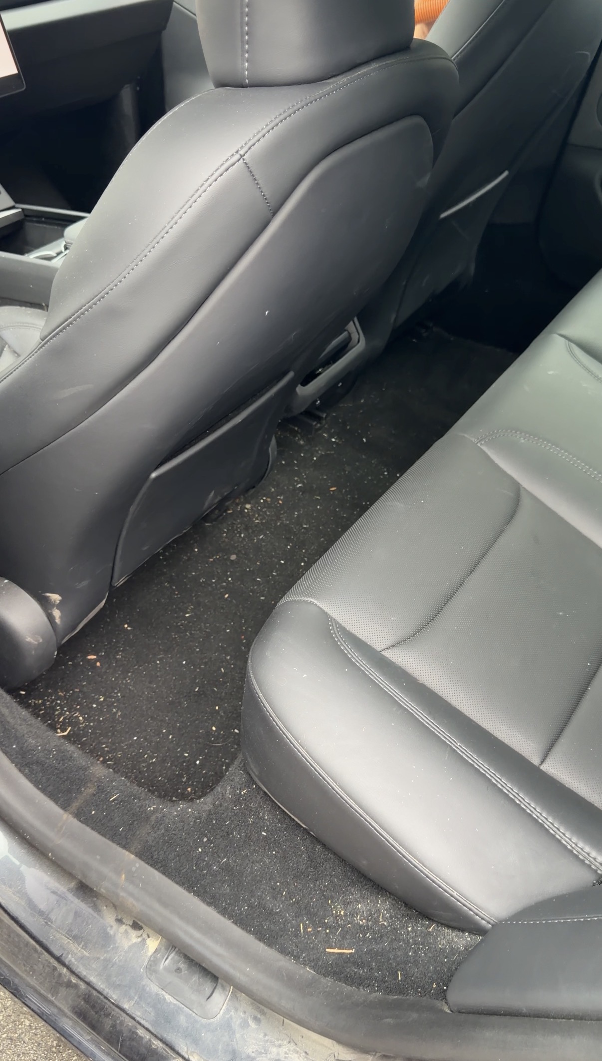 Tesla Model 3 rear seat bench before detailing, dirt and debris