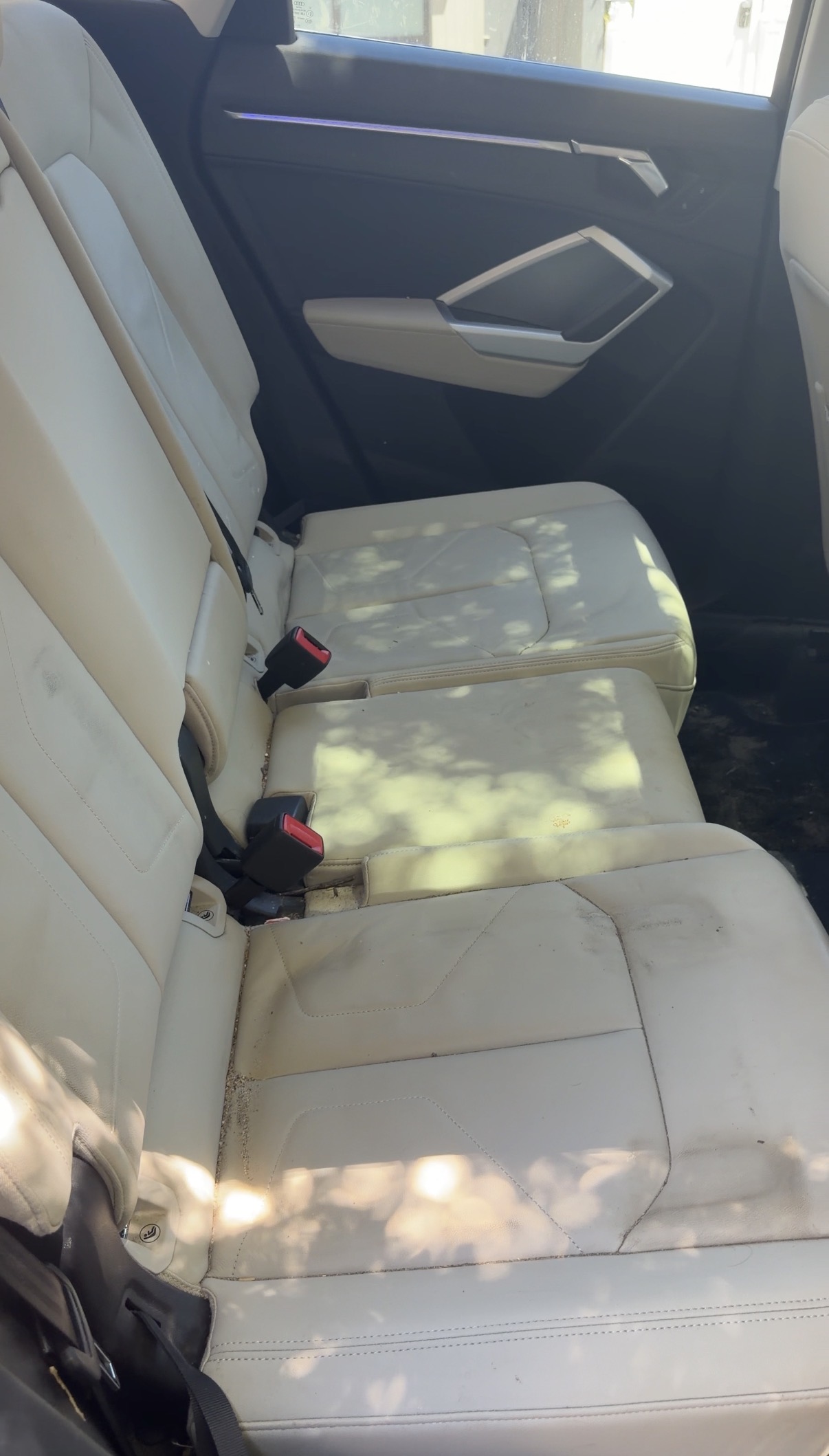 Audi Q3 rear seat cushions before detailing, stained
