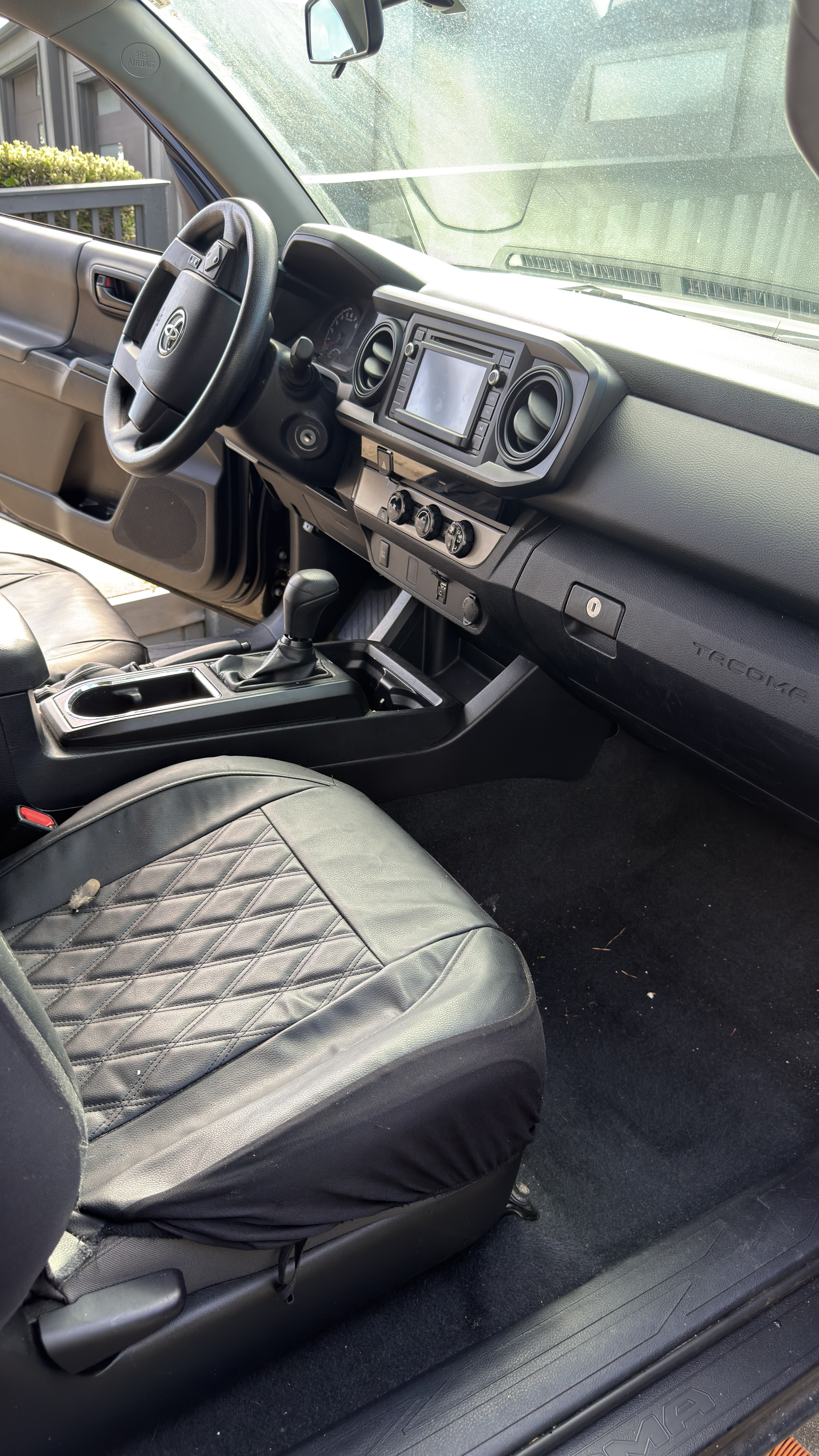 Toyota Tacoma driver cockpit before detailing, light debris on floor