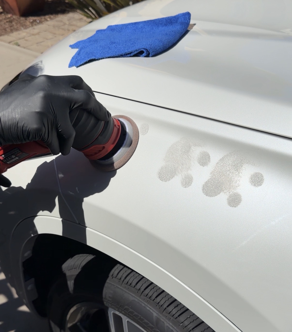 Paint correction with rotary polisher on white vehicle