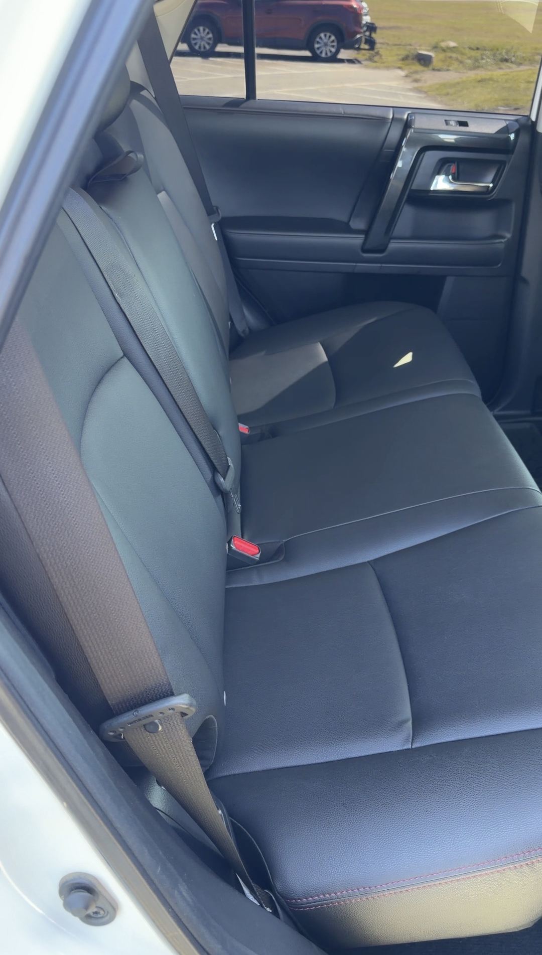 Clean black rear bench seat with red stitching in a Toyota 4Runner
