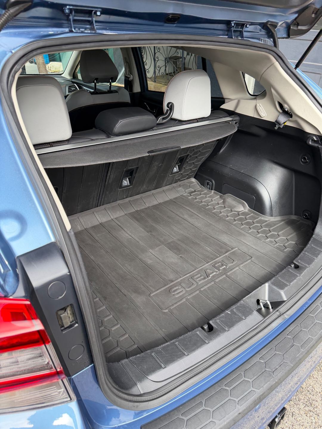 Clean cargo area and rubber cargo tray of a Subaru Crosstrek after detailing