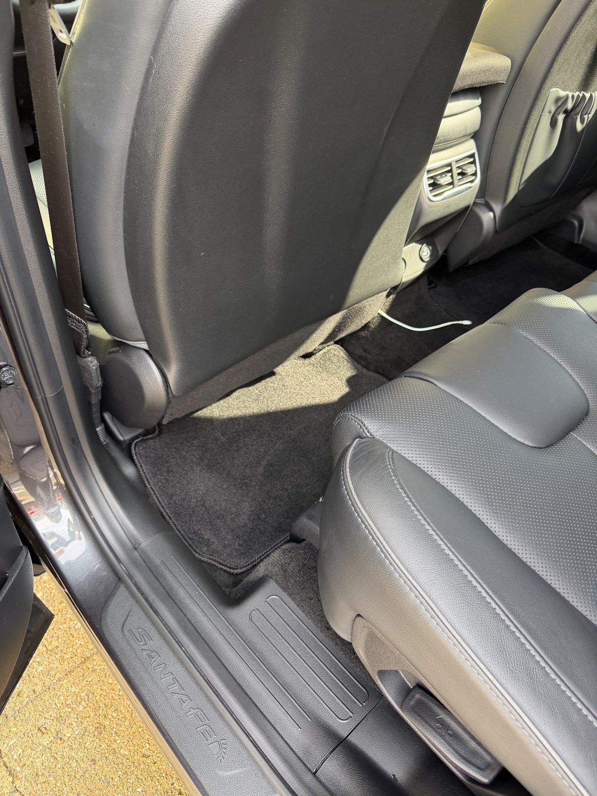 Vacuumed rear footwell carpet of a Hyundai Santa Fe after detailing