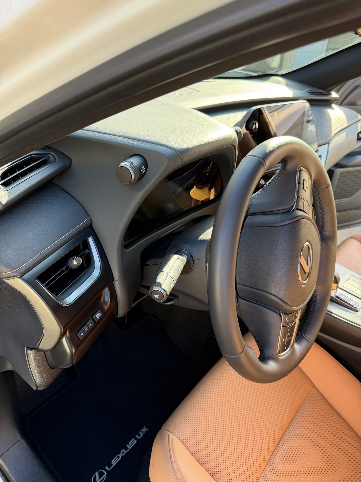 Clean steering wheel and dash of a white Lexus UX after detailing