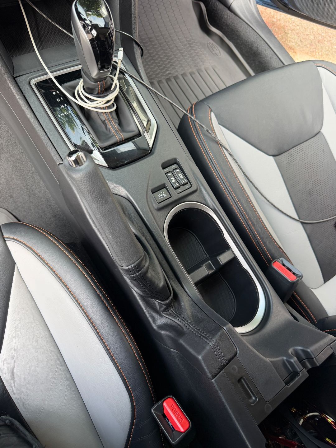 Clean centre console and cupholders of a Subaru Crosstrek after detailing