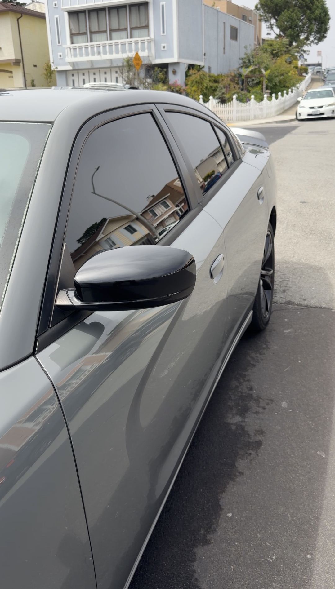 Clean grey Dodge Charger front door, mirror and side glass after an exterior detail