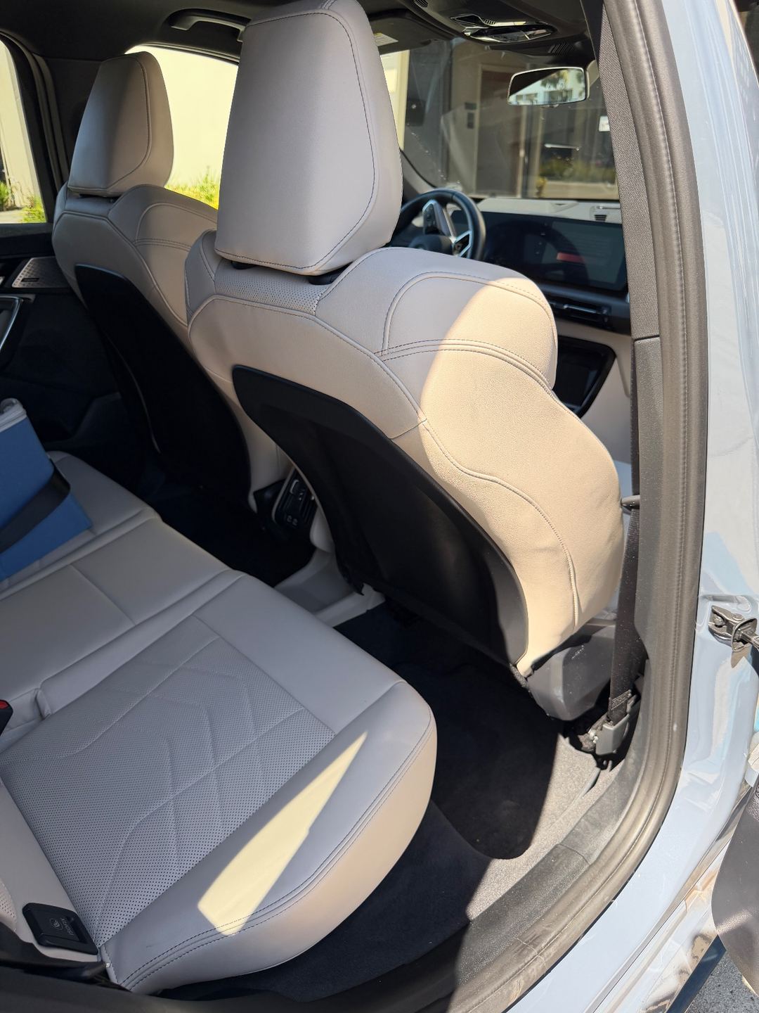 Rear passenger-side footwell of a grey BMW X1 before detailing