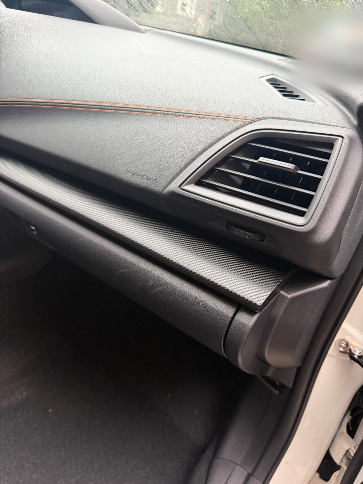 Scuffed dash trim and dusty vent on the passenger side of a Subaru Crosstrek before cleaning