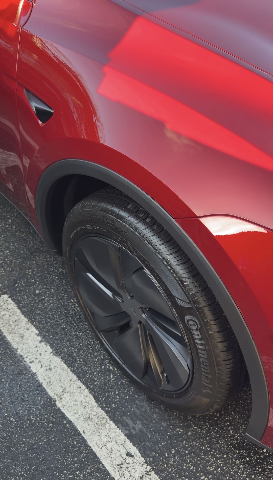 Clean black Tesla Model Y aero wheel and Continental tyre after an exterior detail