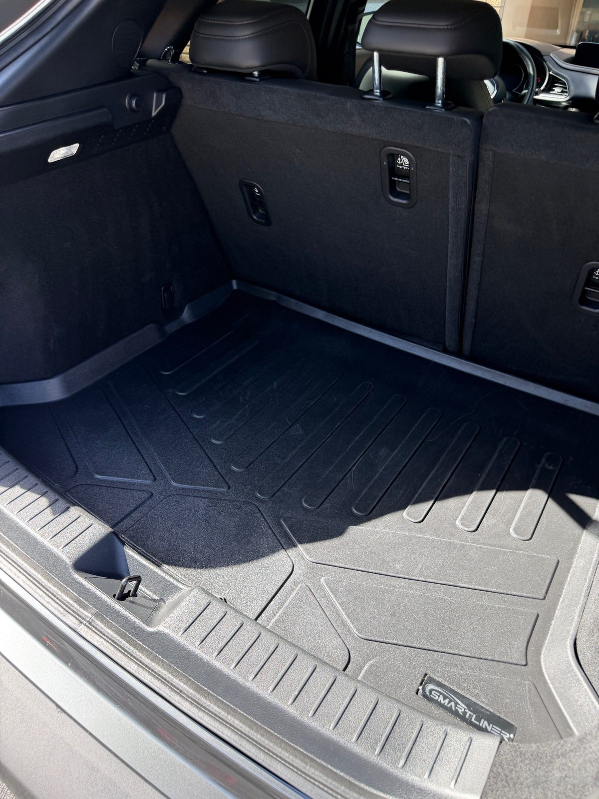 Cargo area of a grey Mazda CX-30 after detailing, clean liner