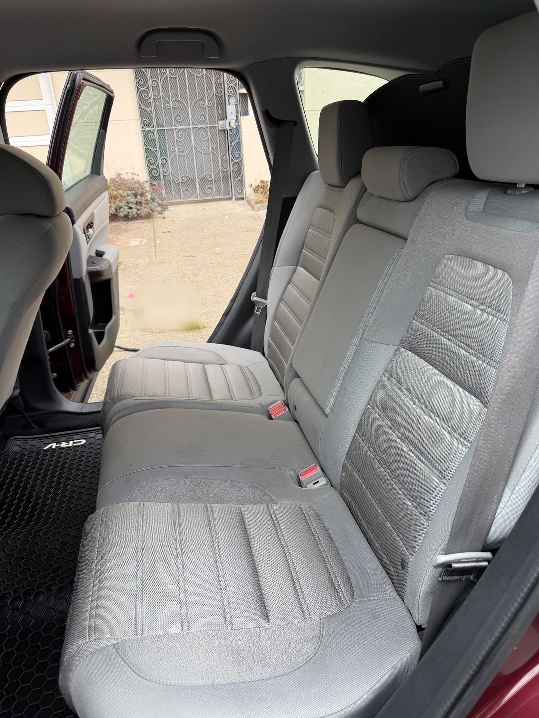 Rear bench of a maroon Honda CR-V after an interior detail, the grey cloth seat clean and stain-free