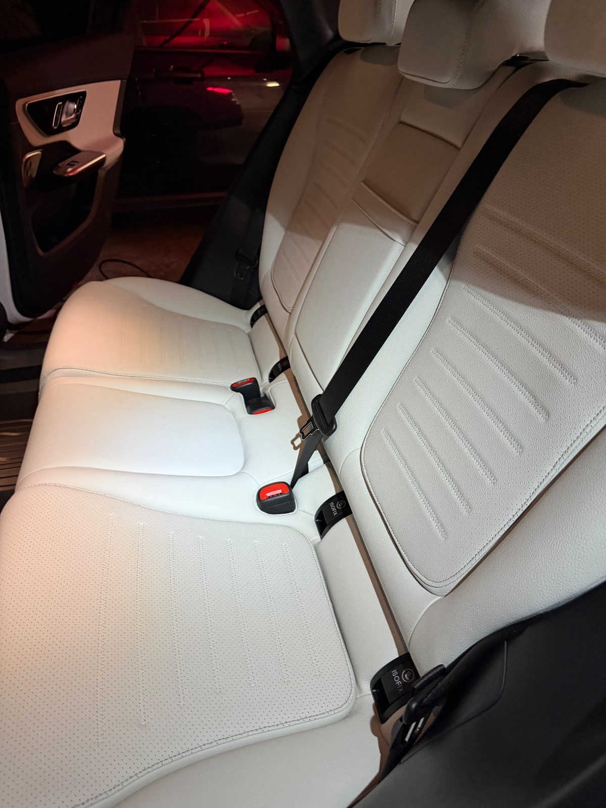 Rear bench seat of a white Mercedes GLC after cleaning, clean cream leather