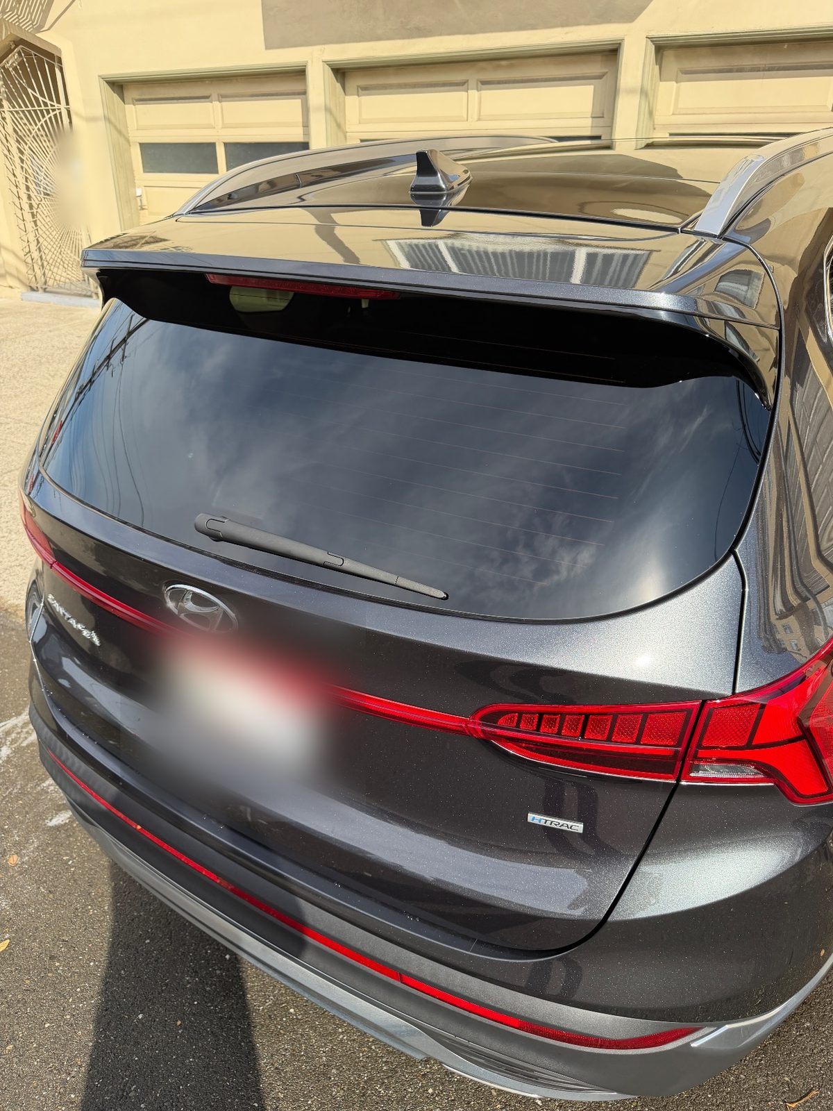 Rear of a dark grey Hyundai Santa Fe HTRAC with clean glass and paint after detailing