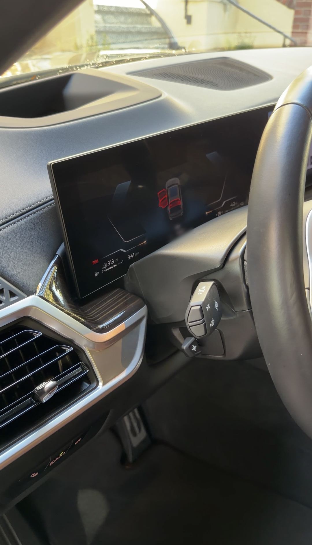 Instrument cluster of a BMW X5 showing the curved display in park