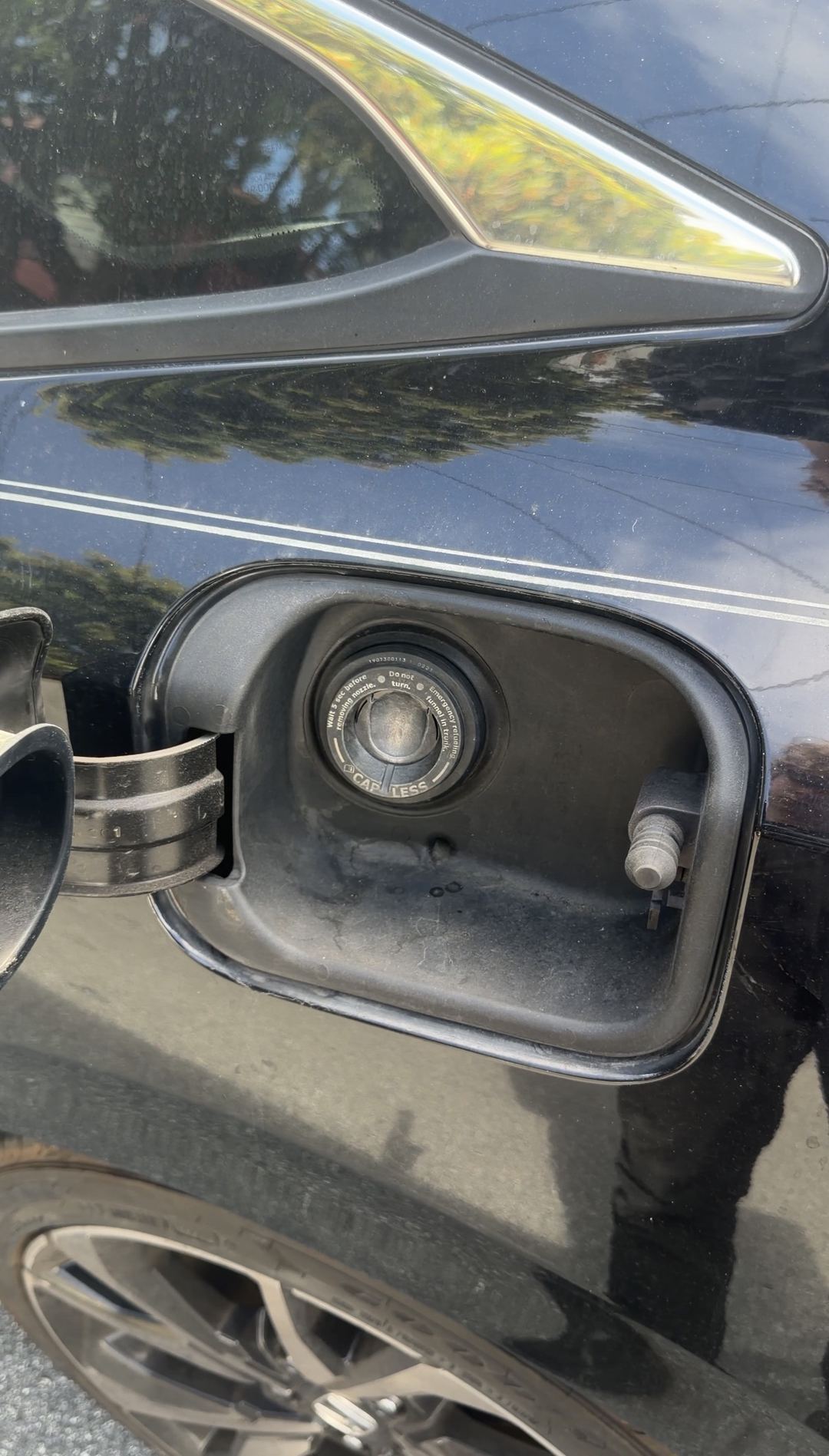 Grime inside the fuel door of a Honda Civic before cleaning