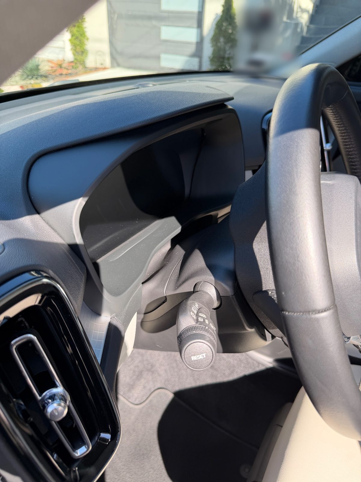 Clean steering column stalk and instrument cluster hood in a Volvo XC40 after detailing