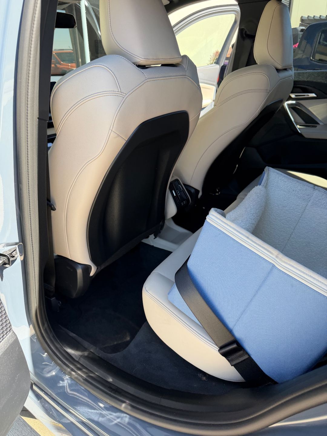 Rear driver-side footwell of a grey BMW X1 before detailing