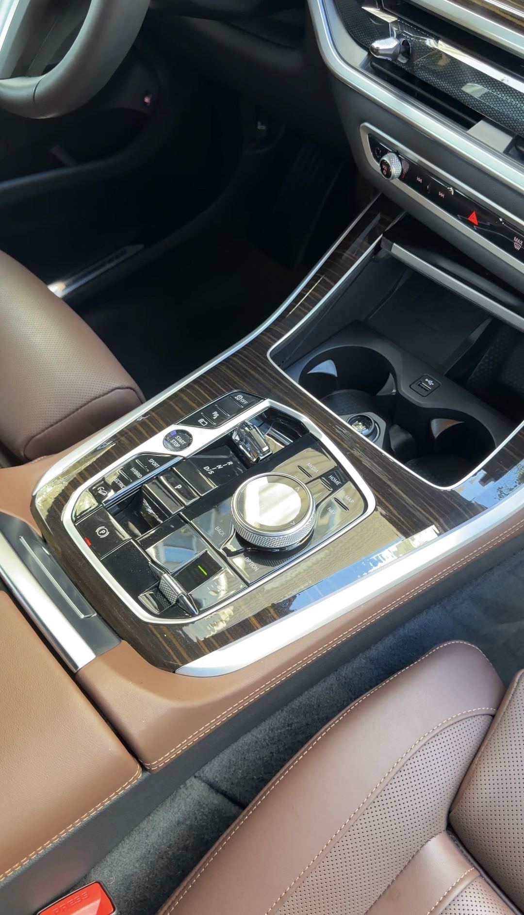 Cleaned centre console of a BMW X5 showing the electric, hybrid and sport drive-mode buttons
