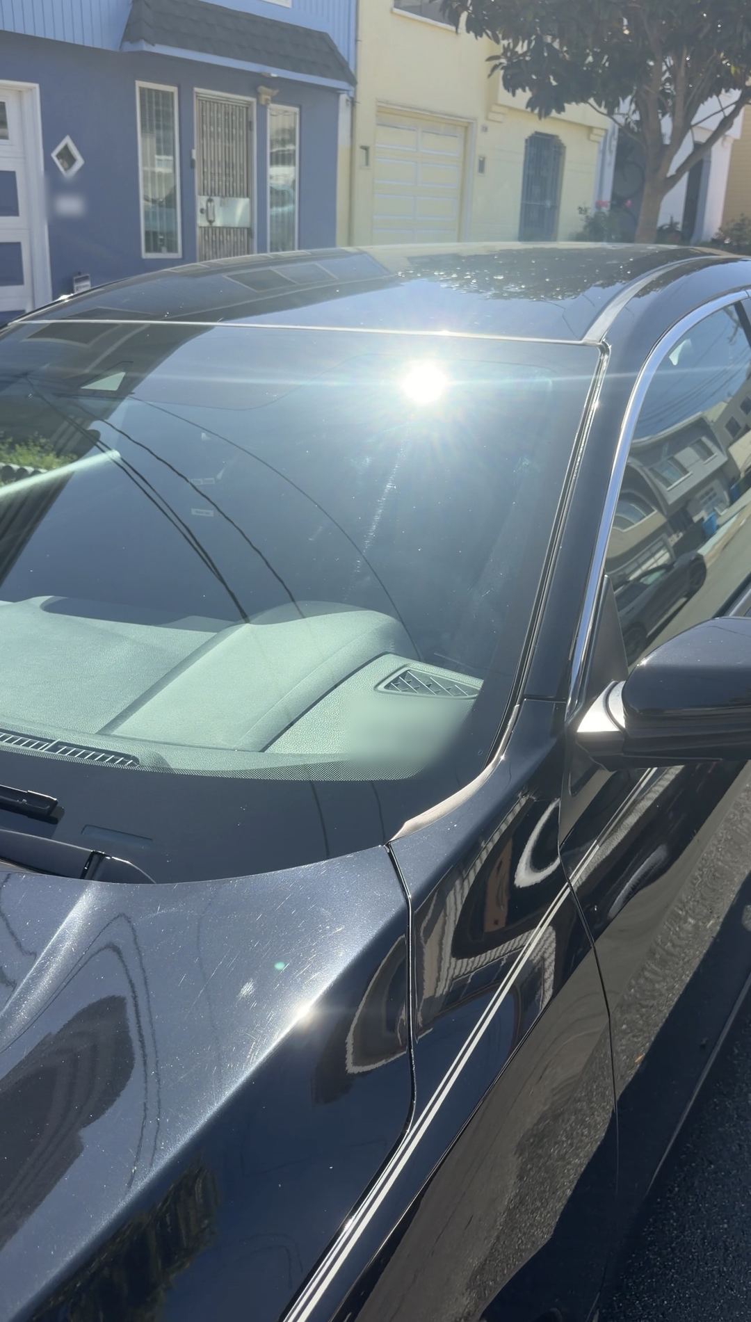 Clean windshield and glossy black paint on a detailed Honda Civic