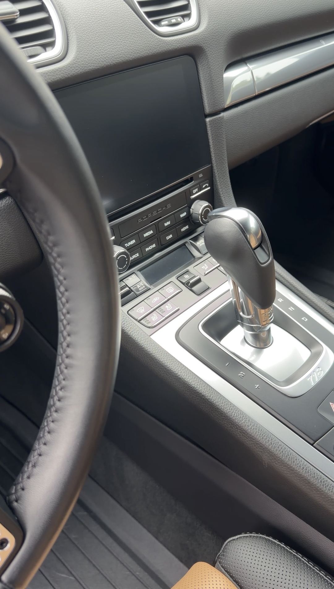 Clean centre console and infotainment screen of a Porsche 718 Cayman S after an interior detail.
