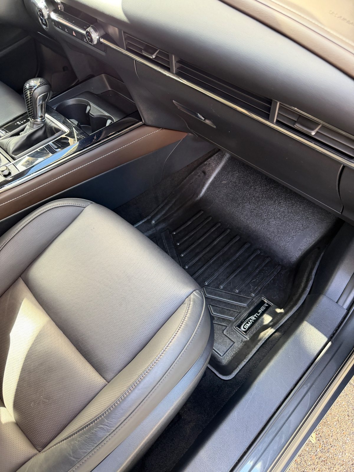 Front passenger footwell of a grey Mazda CX-30 after detailing, clean liner