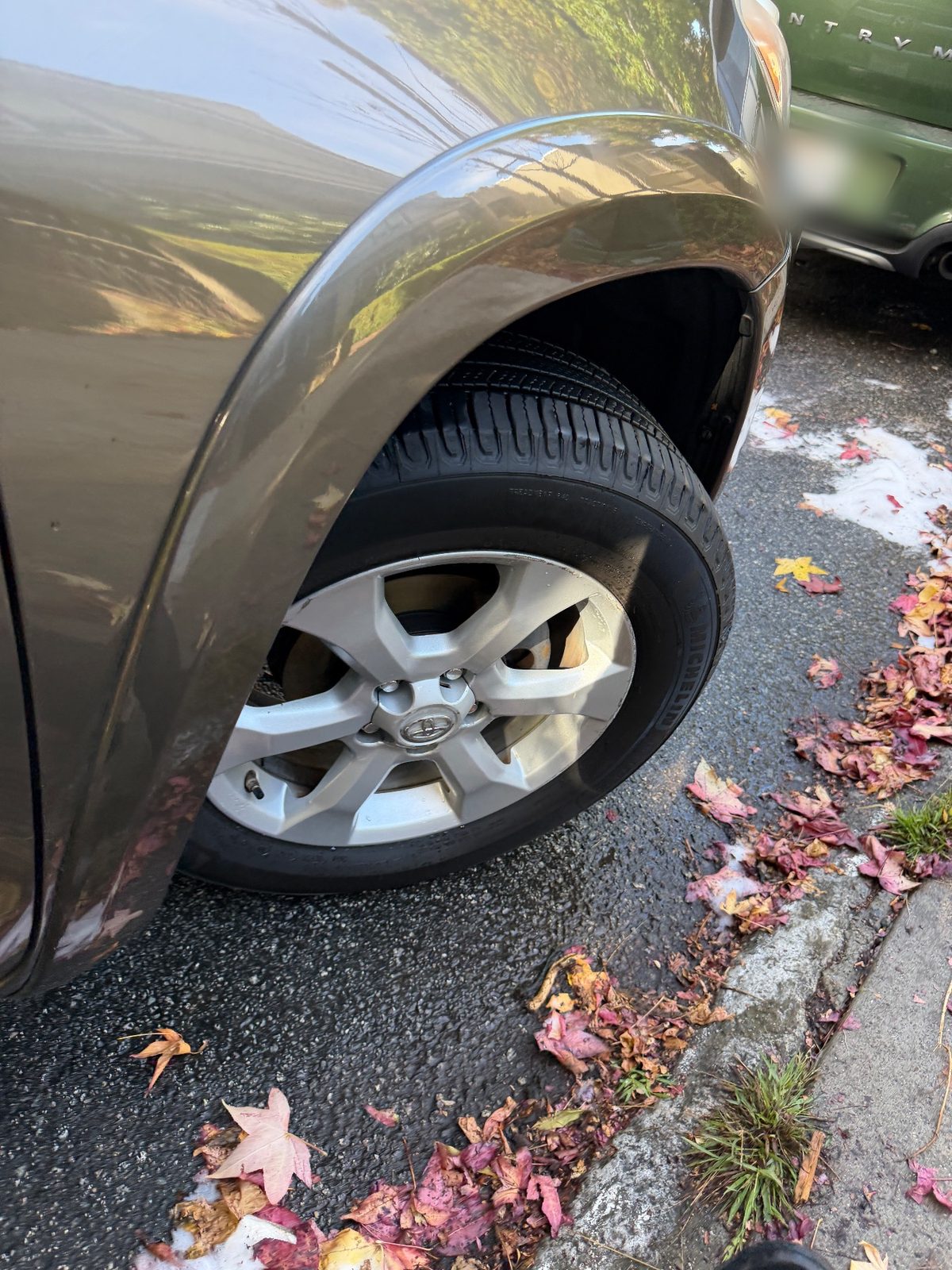 Clean front alloy wheel and fender of a 2011 Toyota RAV4 after washing