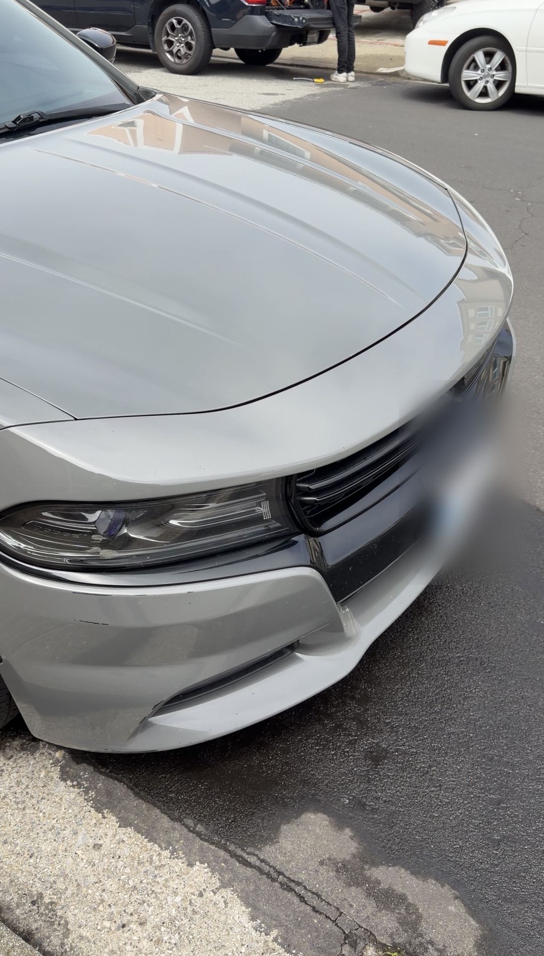 Clean grey Dodge Charger hood, grille and headlight after an exterior detail
