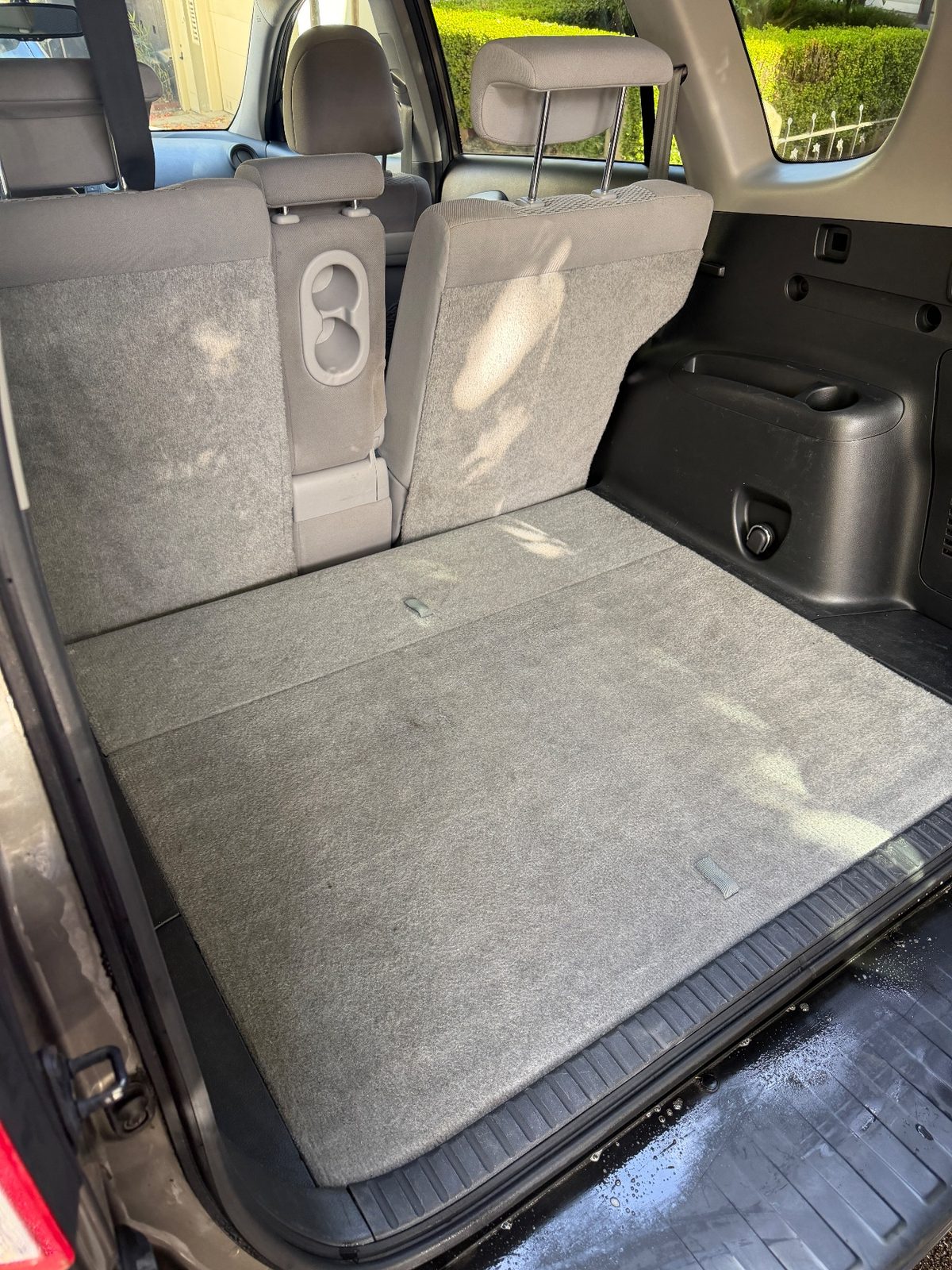 Cleaned cargo area of a 2011 Toyota RAV4 with folded rear seats