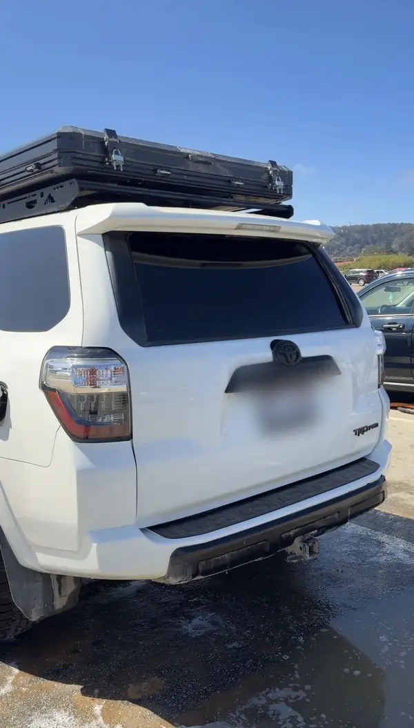 Rear of a clean white Toyota 4Runner TRD Pro with a rooftop tent