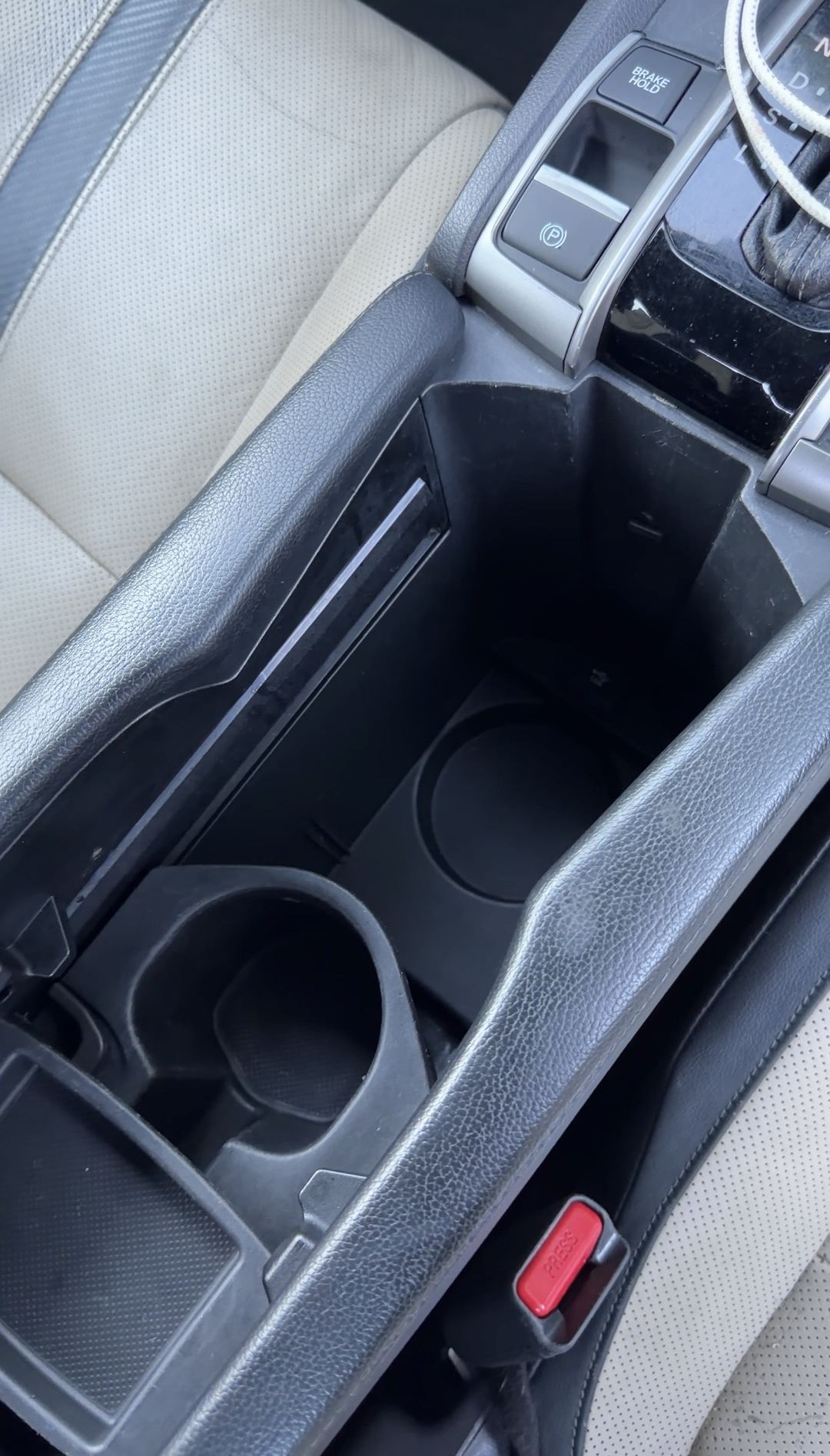 Cleaned centre console and cupholders of a Honda Civic after interior detailing